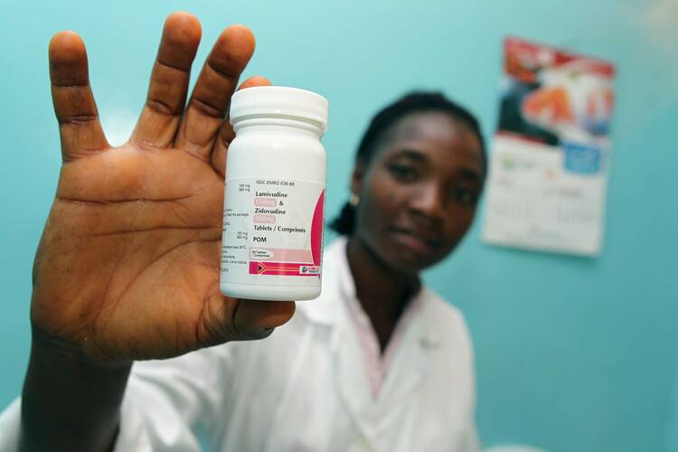 A pharmacy technician displays one of the drugs used to treat patients with HIV at Our Lady of Apostles Hospital in Akwanga, Nigeria, in this 2010 file photo. Like many such efforts, the hospital has been reliant on PEPFAR funding from the U.S. (CNS photo/Nancy Phelan Wiechec)